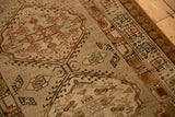 Geometric pawn design motifs and worn, low-pile texture on a distressed vintage Serab runner.