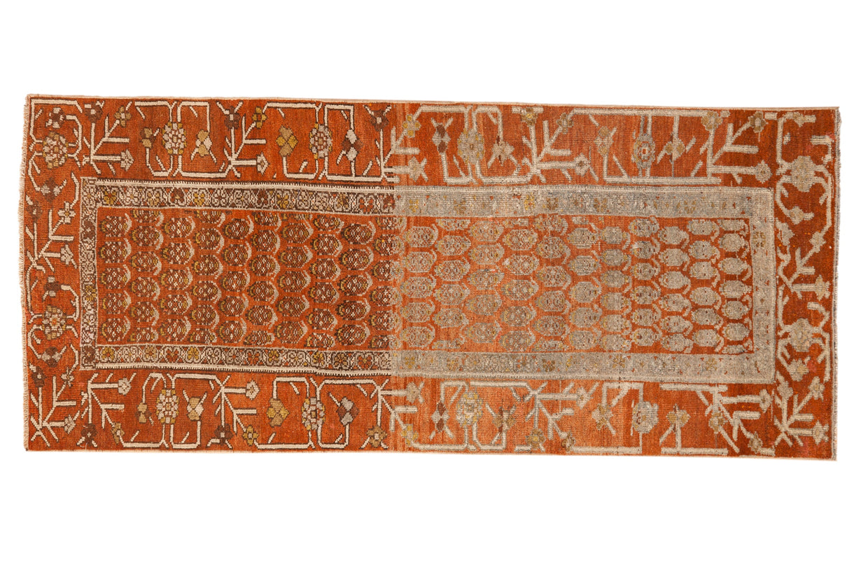 Antique Hamadan runner with botehs on a distressed terracotta field and a geometric vine border.