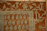Antique Hamadan rug corner showing the rust boteh pattern and geometric silver vine border.