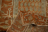 The secure machine binding and tightly woven back of a distressed antique Hamadan rug.