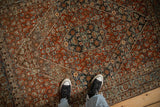 A top-down perspective showing the scale and detailed Herati pattern of a vintage Bijar rug.