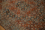 Detailed corner view of a vintage Bijar rug showing the Samovar Turtle border and rust-red Herati field.