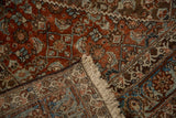 Folded corner of a vintage Persian Bijar rug revealing its dense hand-knotted weave and foundation.