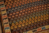 Staggered germinating blossoms in madder red, powder blue, and saffron yellow on antique Caucasian rug.