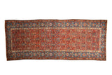 Antique Kurdish Hamadan runner with a red cartouche and boteh field, framed by a wide sky blue border.