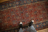 Cherry red field with cartouche-like vines and botehs on an antique Persian Hamadan runner rug.