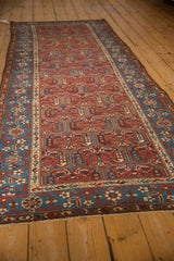 Angled view displaying the full length of the antique Kurdish Hamadan runner's intricate pattern.