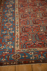 Intricate hand-knotted detail of a Kurdish Hamadan's sky blue border and geometric red field.