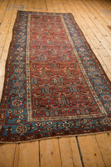 Full length of the fine antique Kurdish Hamadan runner, viewed from a high angle to show the repeating pattern.