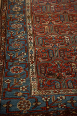 Sky blue pomegranate vine border contrasts with the intricate red field of an antique Kurdish runner.