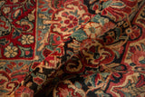 Plush pile detail of the vintage Sarouk carpet, highlighting cherry red roses and dusty teal vines.