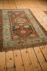 The distressed texture and abrash of a vintage Malayer rug seen from a low angle perspective.