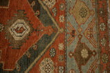 Distressed hand-knotted pile of a Malayer rug, showing the rust field against the sky blue border.