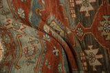 Soft, textured pile of a distressed Malayer rug showing even wear in terracotta and blue.