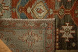 Folded corner of a vintage Malayer rug revealing its hand-knotted pile and flat woven back.