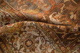 Wide cartouche-like border and curvilinear field on the distressed vintage Malayer carpet.