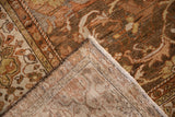 Distressed Malayer carpet showing the earthy brown pile and hand-knotted foundation.