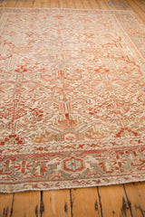 Perspective view across the vintage Persian Heriz rug, highlighting its low pile and distressed character.