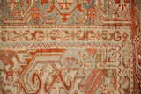Detail of the hand-knotted Turtle Samovar border motif in terracotta, dusty blue, and ivory on a vintage Persian Heriz.