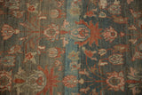 Close-up of the distressed hand-knotted pile showing heavy color abrasion in dusty teal and silver.