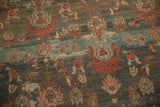 Nuanced floral details in terracotta and rose on the time-softened, abrashed pile of a vintage carpet.