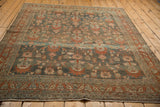 Angled view of the vintage Bibikabad rug's abrashed field with dusty teal, terracotta, and rose florals.