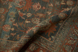 A fold across the vintage Bibikabad carpet shows the distressed, hand-knotted texture and abrashed colors.