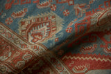 Softly folded vintage Hamadan rug showing textured knot heads and geometric motifs in blue and ruby red.