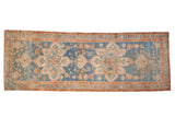 Antique distressed Northwest Persian rug runner with geometric starburst medallions on a sky blue and terracotta field.