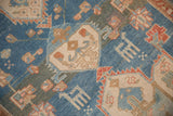 Worn texture and heavy color abrashes on the geometric patterns of an antique Persian runner.