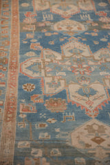 Low, worn pile texture of an antique Persian runner with sky blue and terracotta geometric designs.