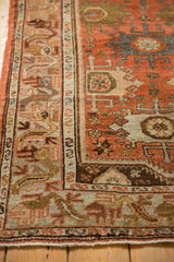 Distressed vintage Malayer runner: serpent border, palmette field, dusty terracotta, oxidized silver.