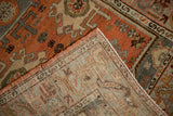 Hand-knotted Malayer rug with dusty terracotta pile, revealing its distinct woven back and secured edge.