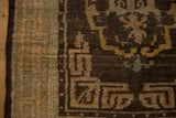 Close-up of the side cord selvage and geometric cloudband border on an antique Tibetan rug.