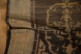 Secured side cord and textured, time-softened brown pile of an antique Tibetan rug.