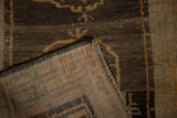Hand-knotted foundation and secured selvage of an antique Tibetan rug with a brown wool pile.