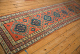 Angled perspective view down the length of the antique Northwest Persian rug runner.
