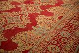 The even, low-pile texture of hand-knotted medallions on a vintage Oushak carpet.
