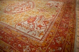 Antique Oushak corner with intricate madder root red border and nuanced gold floral motifs.