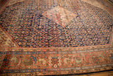 Vintage Mahal carpet border displaying intricate madder root red, powder blue floral arabesques.