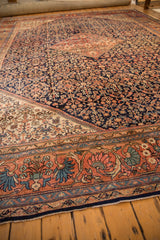 Vintage Mahal rug's main border with rose, navy, and powder blue blossom arabesque.