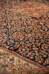 Persian Mahal carpet with henna plant floral motif, expressive border, and aged pile abrash.