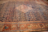 Vintage Mahal carpet's madder root red border featuring intricate blossoms and arabesque motifs.