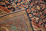Hand-knotted vintage Persian Mahal carpet detail showing deep navy, dusty rose patterns, and woven reverse.