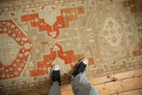Distressed pile on a vintage Malayer runner with terracotta medallions and small animal motifs.