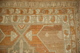 Worn knot heads and geometric borders in terracotta and silver on a vintage Malayer runner.