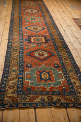 Angled perspective of an antique Persian Heriz runner's repeating geometric medallions.