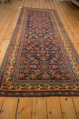 Angled view of an antique Bijar runner showing color abrashes across its allover Herati motif.