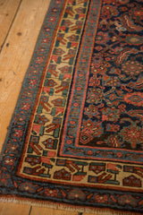 Close detail of the antique Bijar runner's geometric border and the low, even wear of its pile.