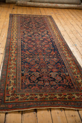 A long perspective view of an antique Bijar runner, emphasizing its length and detailed Herati motif.